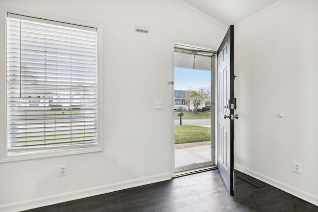 entryway featuring crown molding, baseboards, and wood finished floors