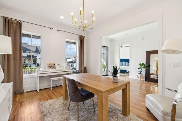 office area with an inviting chandelier, light wood-style flooring, and ornamental molding