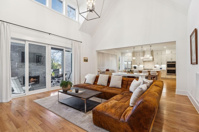 living room with a healthy amount of sunlight, light wood-style floors, and a fireplace