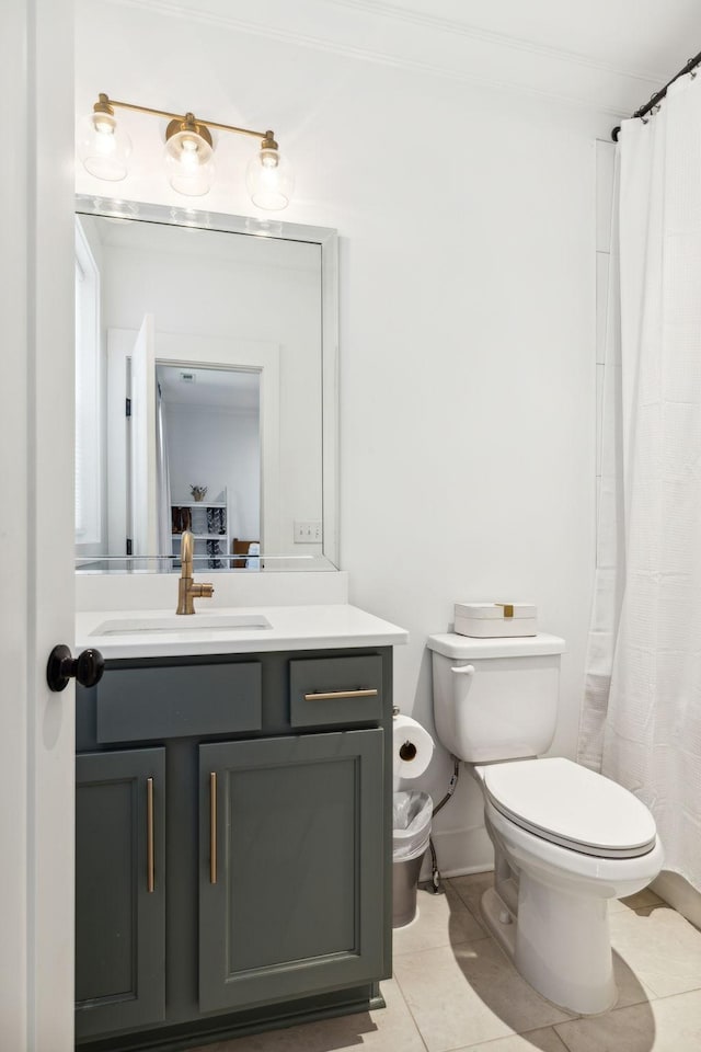 bathroom with toilet, curtained shower, tile patterned flooring, and vanity