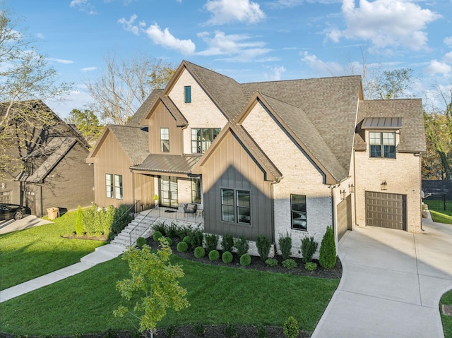 modern farmhouse with driveway, a porch, board and batten siding, and a front yard