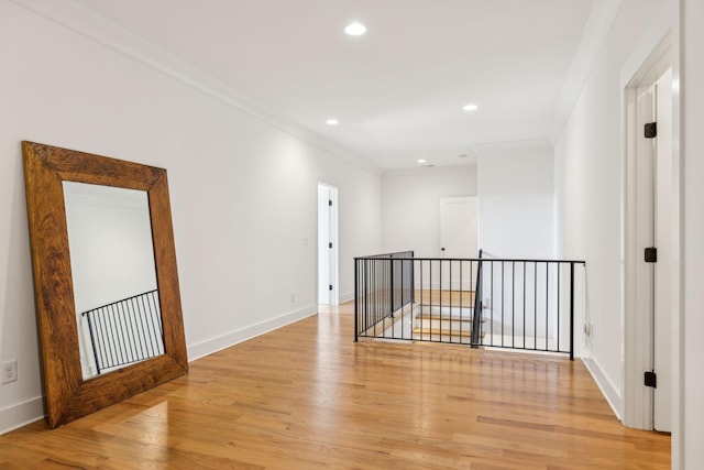 spare room with light wood-style floors, recessed lighting, crown molding, and baseboards