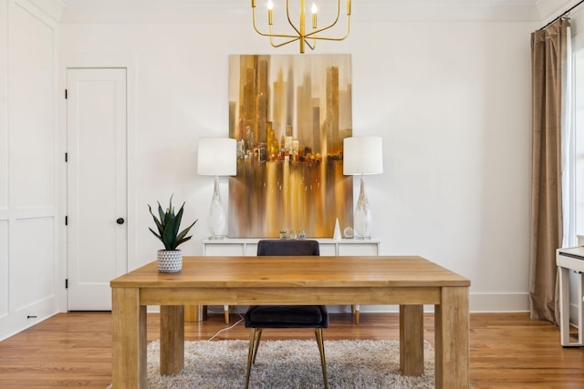 office area featuring baseboards, light wood-type flooring, and a notable chandelier