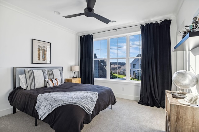 bedroom with baseboards, carpet floors, ceiling fan, and crown molding