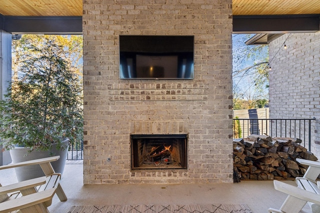 view of patio featuring an outdoor brick fireplace