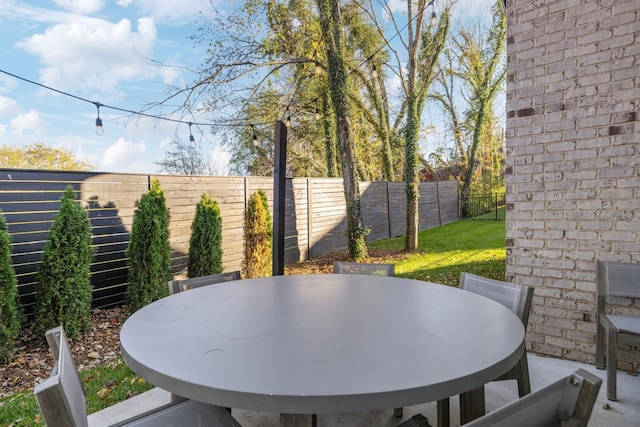 view of patio with outdoor dining area and a fenced backyard