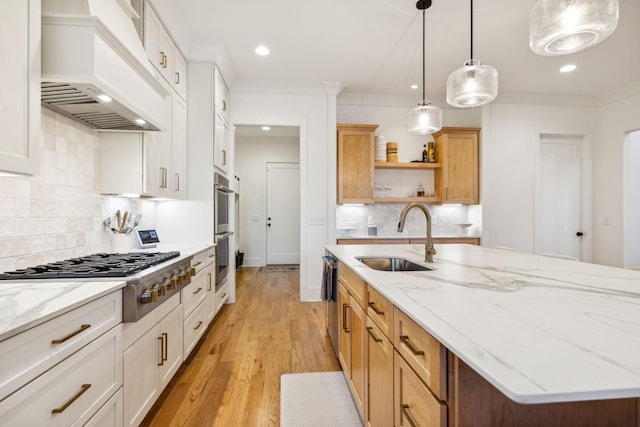 kitchen featuring stainless steel appliances, a sink, custom range hood, open shelves, and crown molding