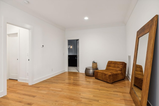 sitting room with baseboards, recessed lighting, light wood-style flooring, and crown molding