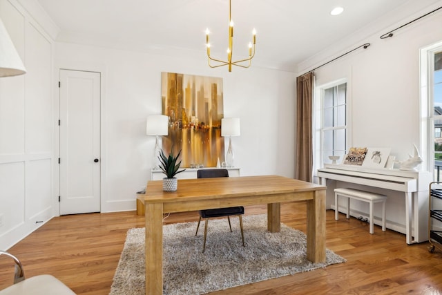 office space featuring light wood finished floors, ornamental molding, and plenty of natural light