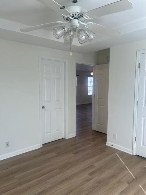 unfurnished room with light wood finished floors, baseboards, and a ceiling fan