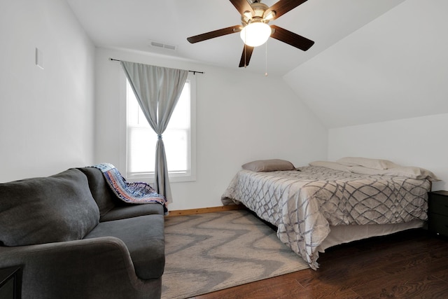 bedroom featuring visible vents, ceiling fan, vaulted ceiling, wood finished floors, and baseboards