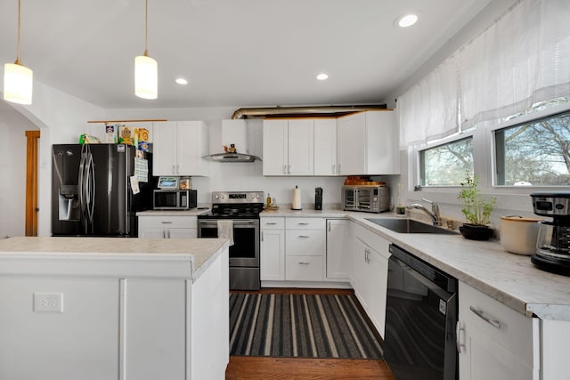 kitchen with decorative light fixtures, light countertops, white cabinetry, a sink, and black appliances