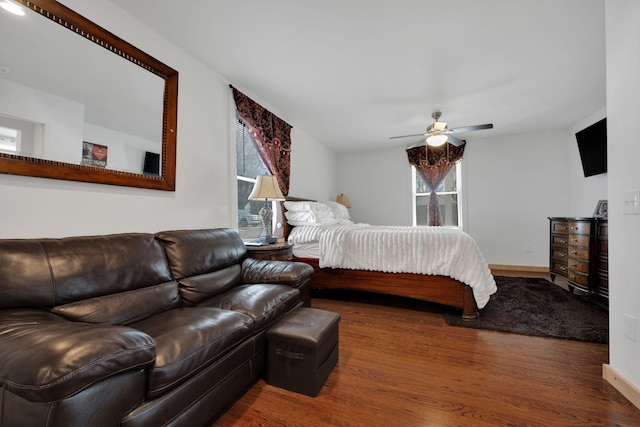 bedroom with baseboards, a ceiling fan, and wood finished floors