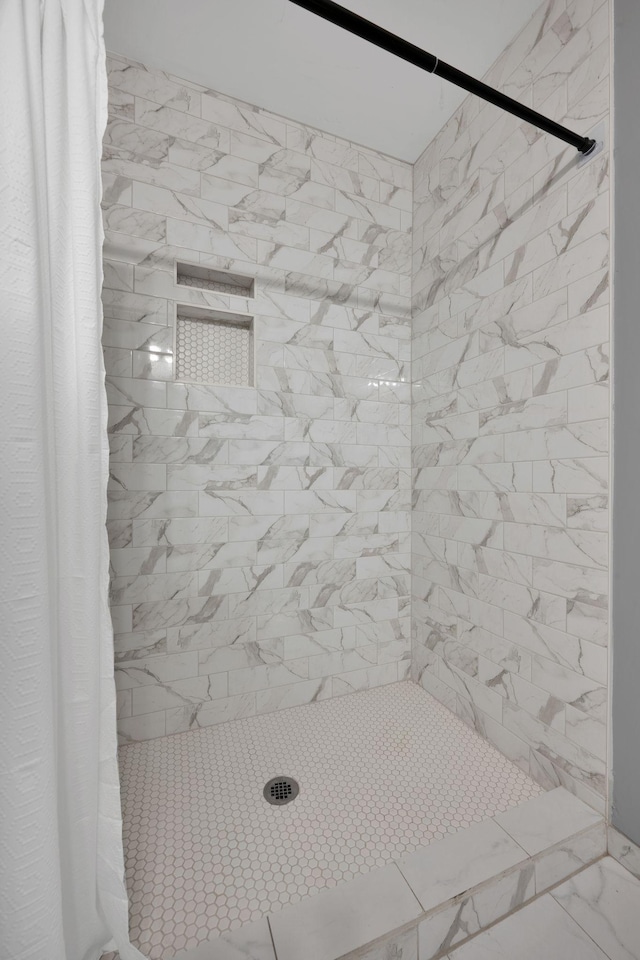 full bathroom with tiled shower