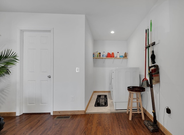 interior space with washing machine and dryer, recessed lighting, baseboards, and wood finished floors