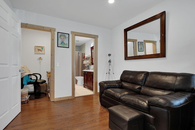 living area featuring baseboards and wood finished floors