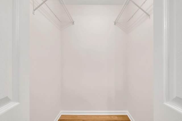 spacious closet with wood finished floors