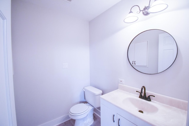 half bath featuring toilet, baseboards, and vanity