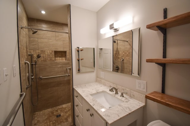 full bath with toilet, a shower stall, and vanity