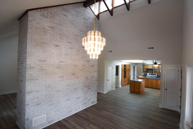 interior space featuring dark wood-style flooring, brown cabinetry, high vaulted ceiling, and visible vents