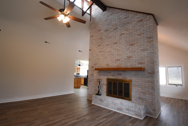 unfurnished living room with wood finished floors, visible vents, baseboards, a ceiling fan, and a brick fireplace