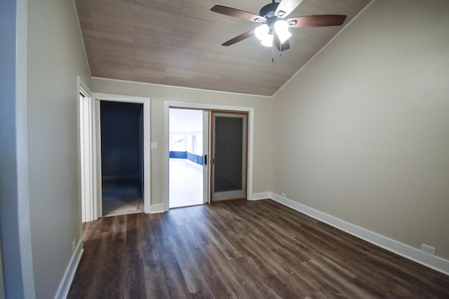 unfurnished room featuring lofted ceiling, baseboards, dark wood finished floors, and a ceiling fan