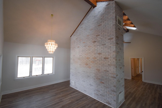 unfurnished room featuring baseboards, brick wall, dark wood-type flooring, high vaulted ceiling, and a notable chandelier