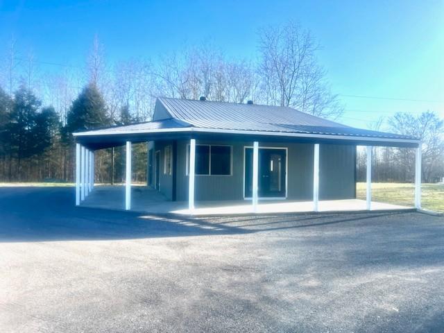 view of front of property with metal roof and an attached carport