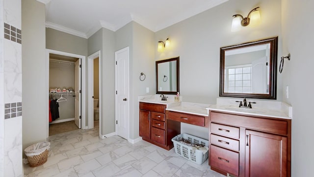 bathroom with double vanity, baseboards, ornamental molding, marble finish floor, and a sink