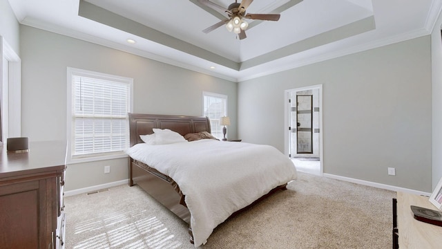 bedroom featuring light carpet and a tray ceiling