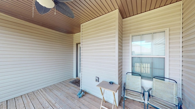 wooden terrace featuring a ceiling fan