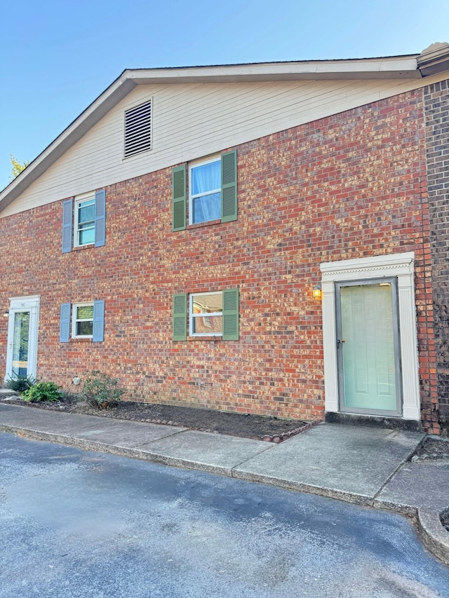 exterior space featuring brick siding