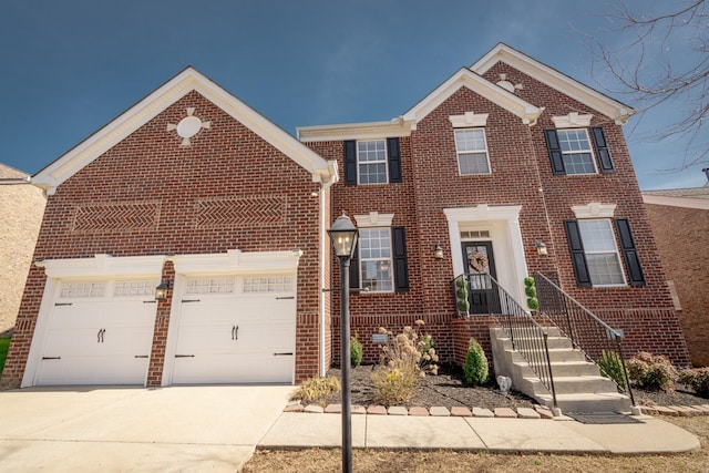 view of front of home featuring a garage, concrete driveway, and brick siding