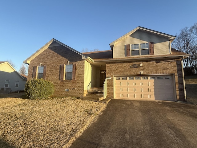 view of front facade with crawl space, driveway, an attached garage, and brick siding