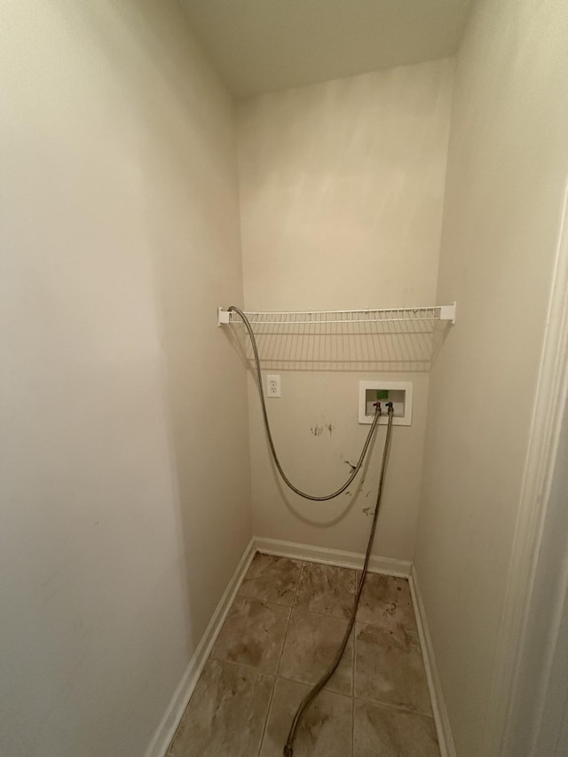 laundry area featuring hookup for a washing machine, laundry area, baseboards, and light tile patterned floors