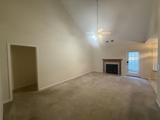 unfurnished living room with light carpet, baseboards, a ceiling fan, a tiled fireplace, and high vaulted ceiling