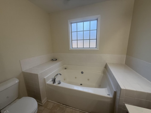 full bathroom with a jetted tub and toilet