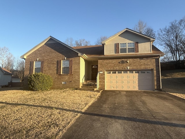 view of front of home featuring a garage, concrete driveway, brick siding, and crawl space