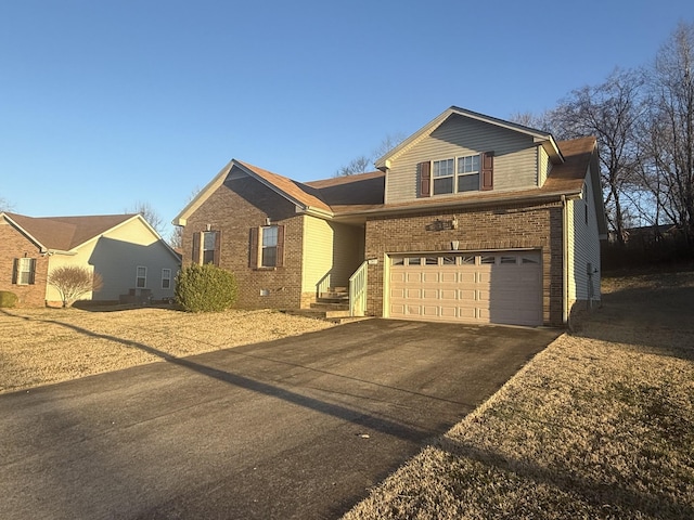 single story home with brick siding, an attached garage, and aphalt driveway