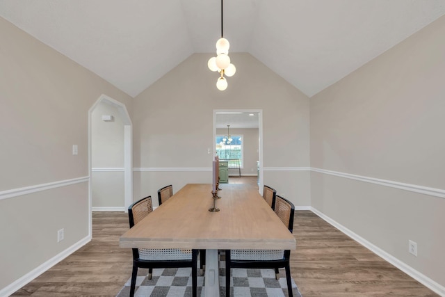 dining area with lofted ceiling, wood finished floors, and baseboards