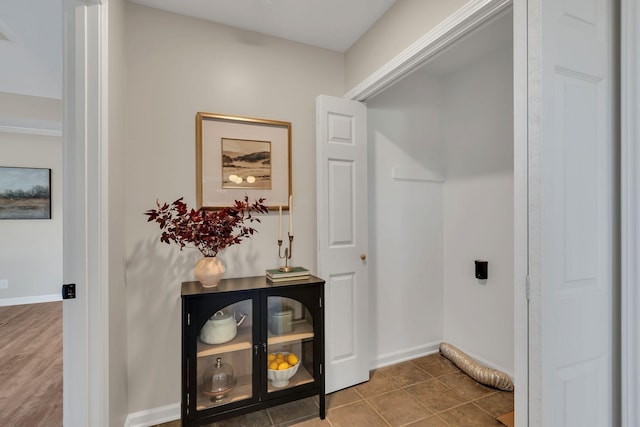 interior space featuring tile patterned flooring and baseboards