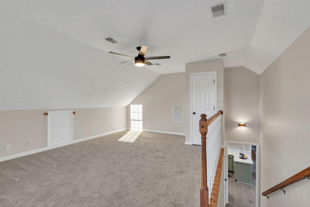 bonus room featuring lofted ceiling, carpet, and visible vents