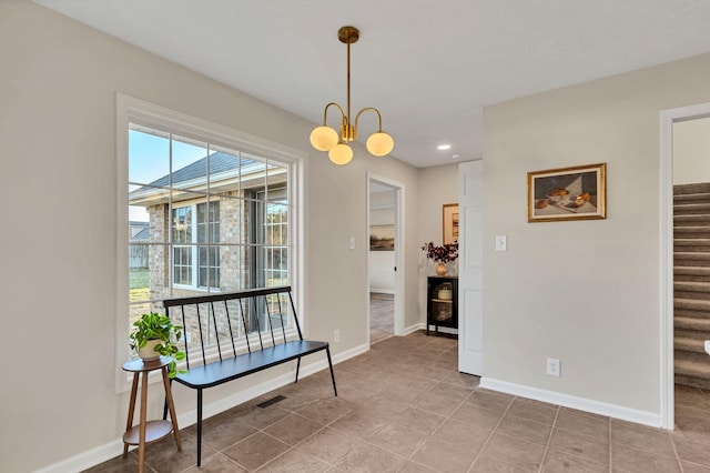 interior space featuring stairway, an inviting chandelier, visible vents, and baseboards