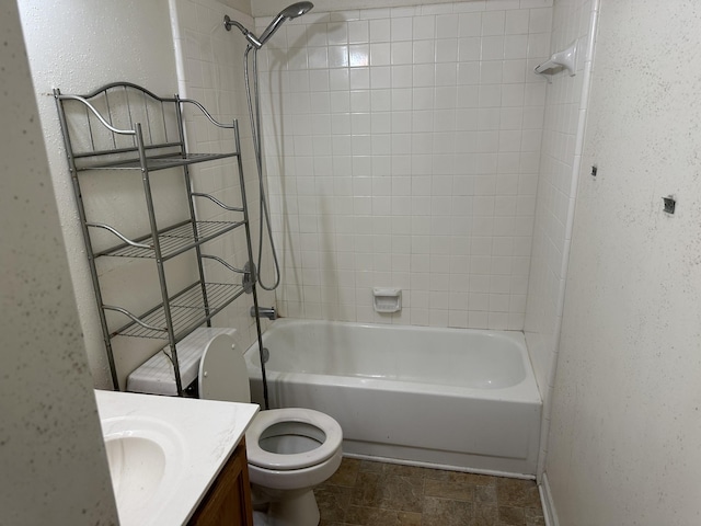 full bath featuring a textured wall, shower / bathing tub combination, vanity, and toilet