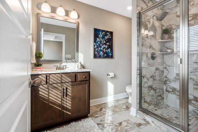 full bath with marble finish floor, toilet, a shower stall, vanity, and baseboards