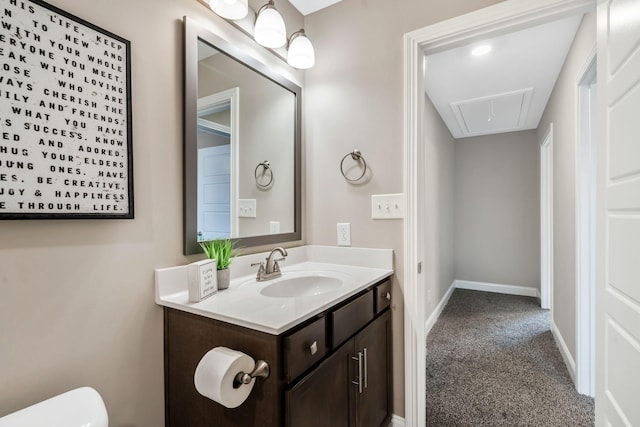 half bathroom with toilet, vanity, and baseboards