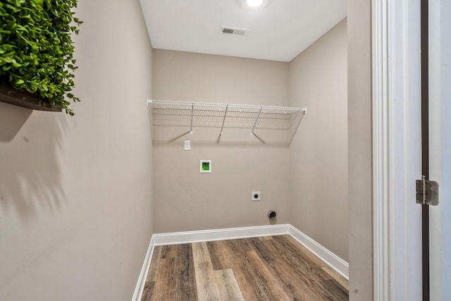 laundry area featuring laundry area, visible vents, wood finished floors, hookup for a washing machine, and electric dryer hookup