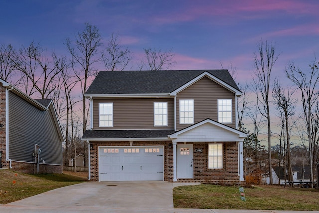 traditional-style house with a shingled roof, concrete driveway, brick siding, and a garage