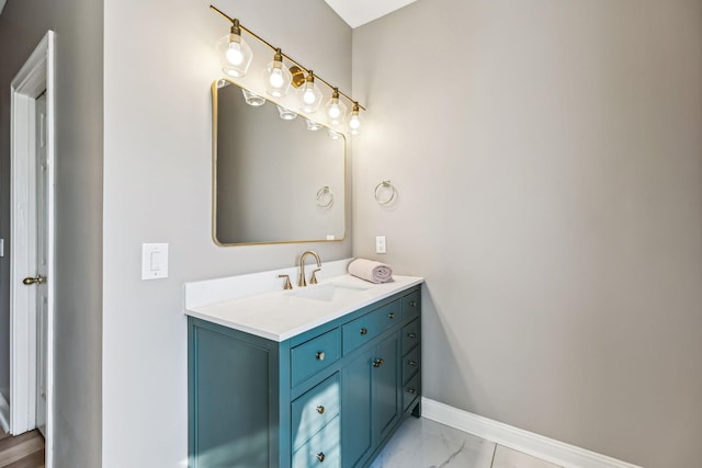 bathroom featuring marble finish floor, vanity, and baseboards