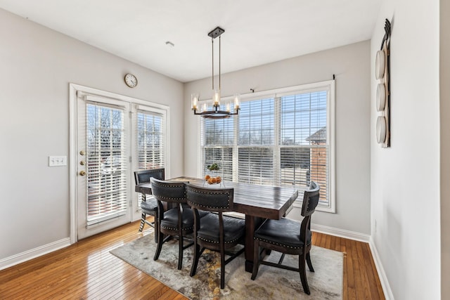 dining area featuring plenty of natural light, baseboards, and hardwood / wood-style floors